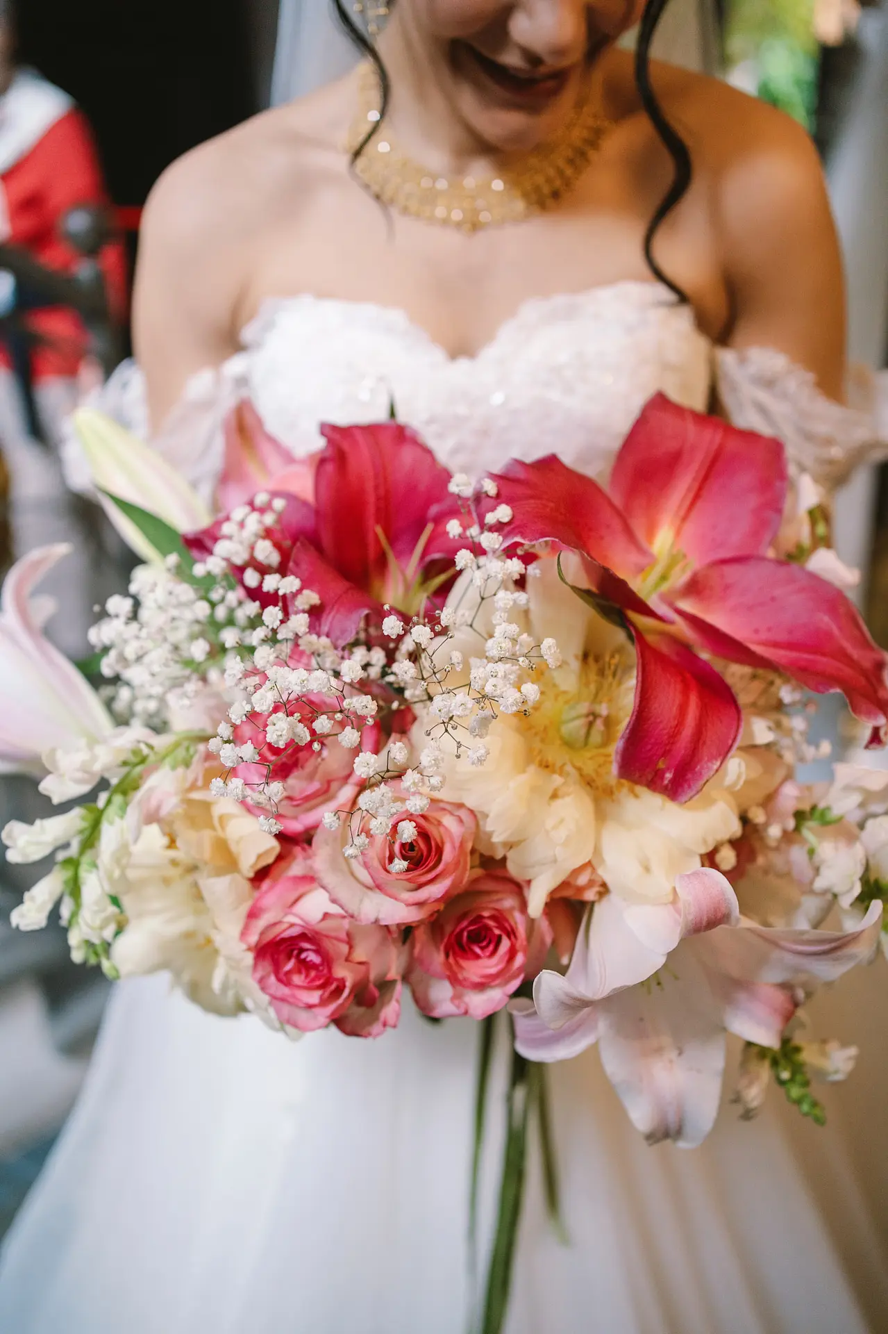 Bride hold close bouquet. Flower red cream shades, big joy big flowers in this gorgeous day.