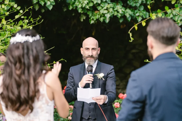 Wedding rehearsal ceremony with officiant giving speech showing what happens at a wedding rehearsal.