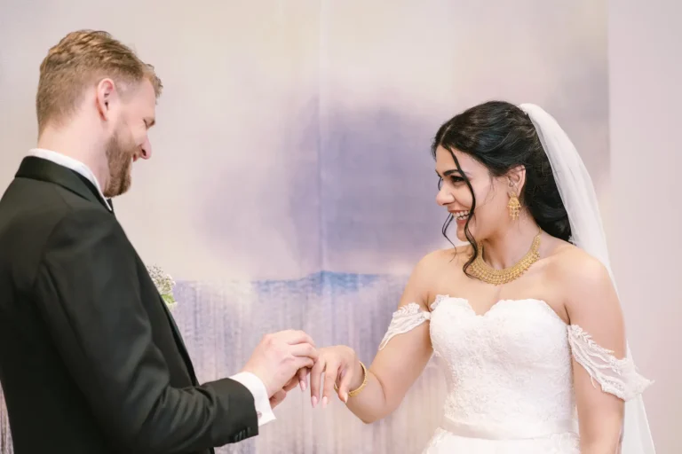 Bride & groom joyful on wedding day, laughing & holding hands, vows.