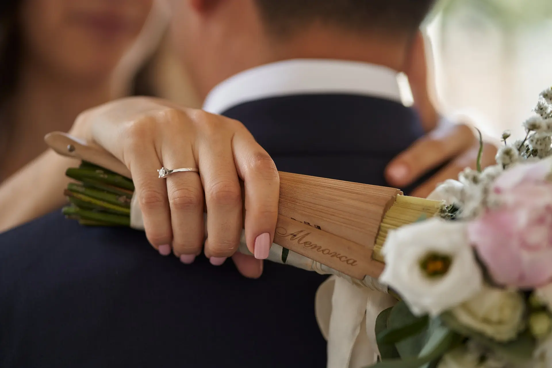 Hand with ring, bouquet, wedding day embrace in Italy. Diamond ring.