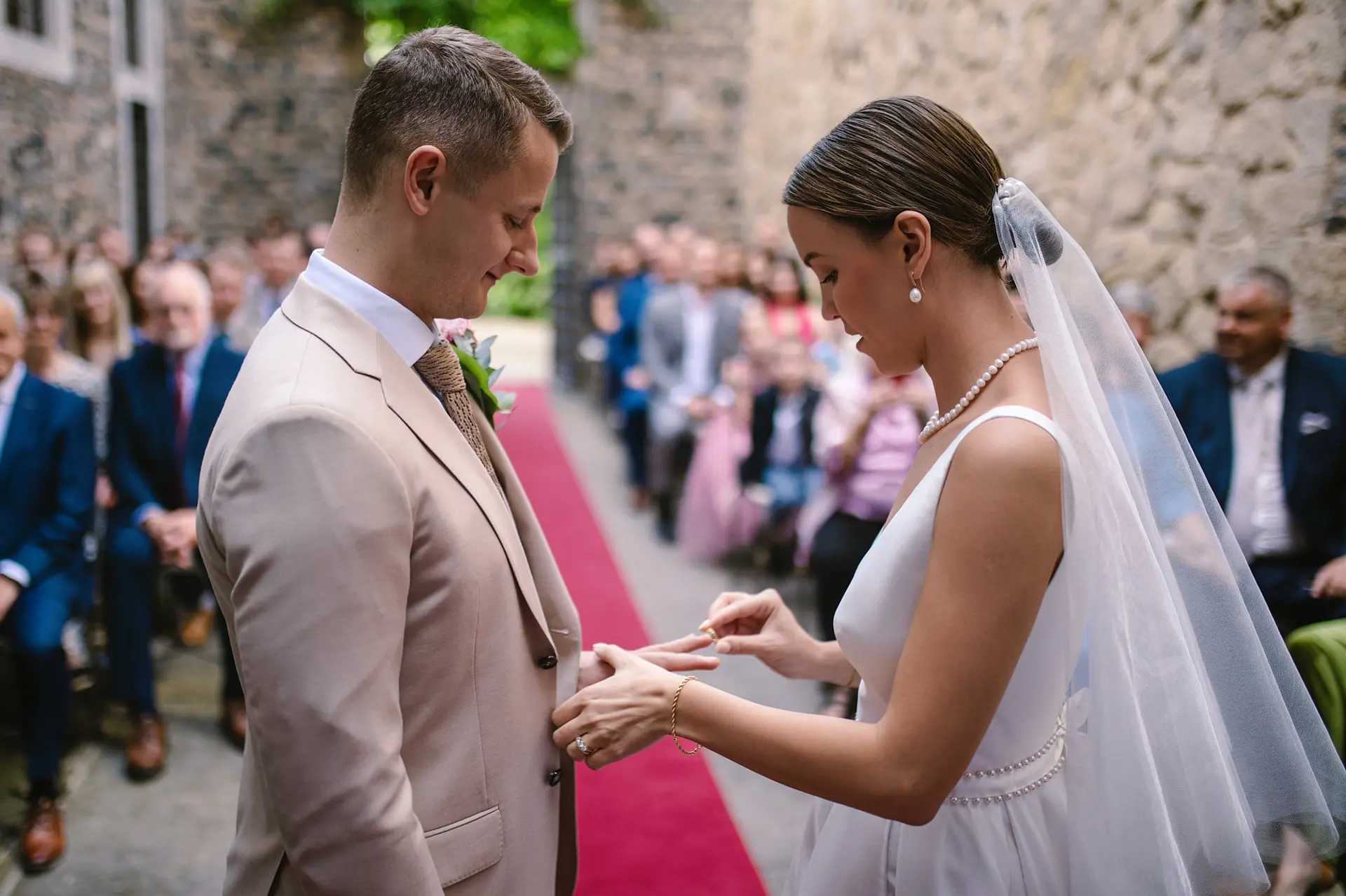 Bride puts ring on groom. Wedding ceremony act of love & union in marriage.