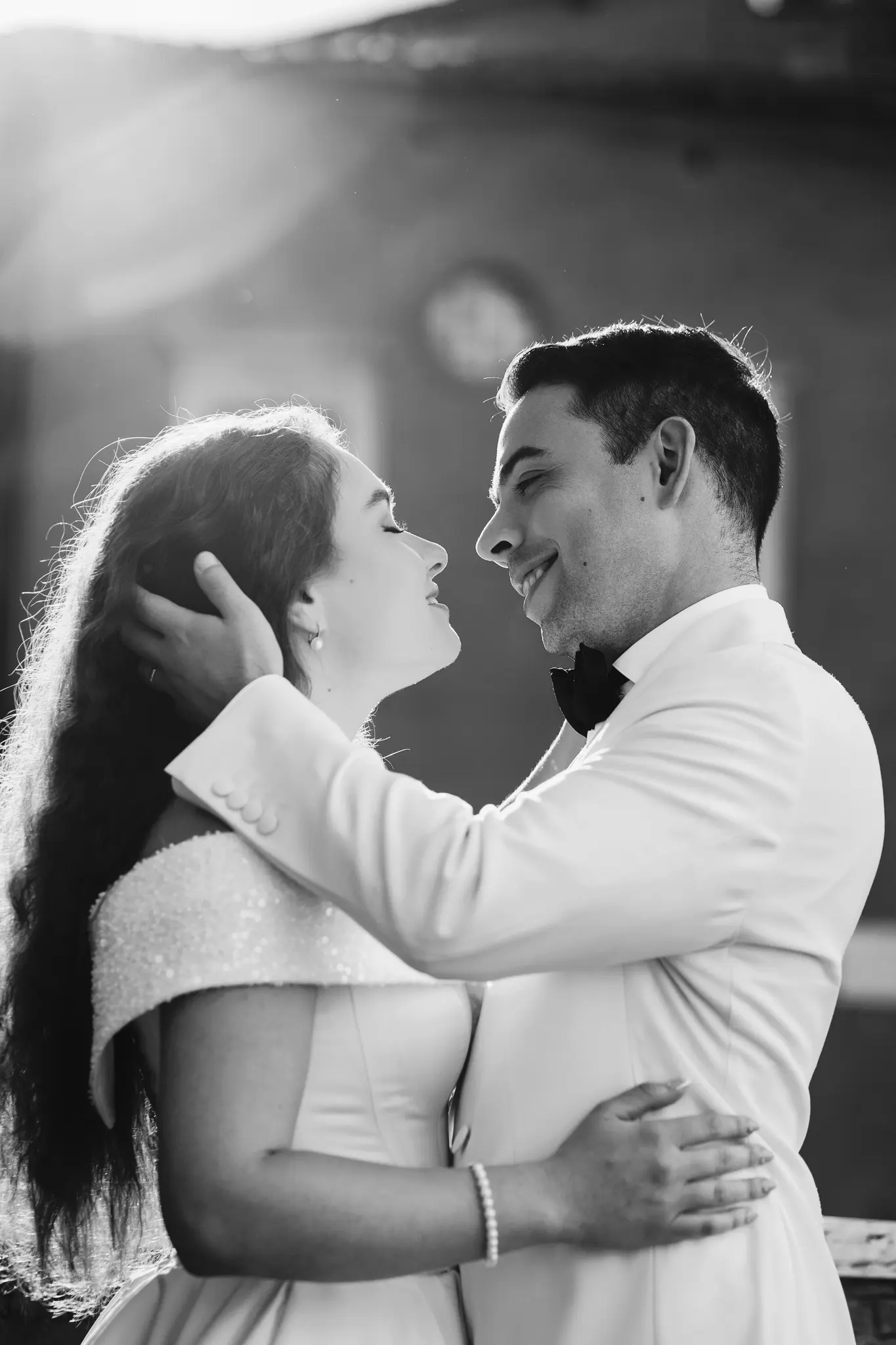 Black and white close-up of a couple sharing an intimate, loving gaze.