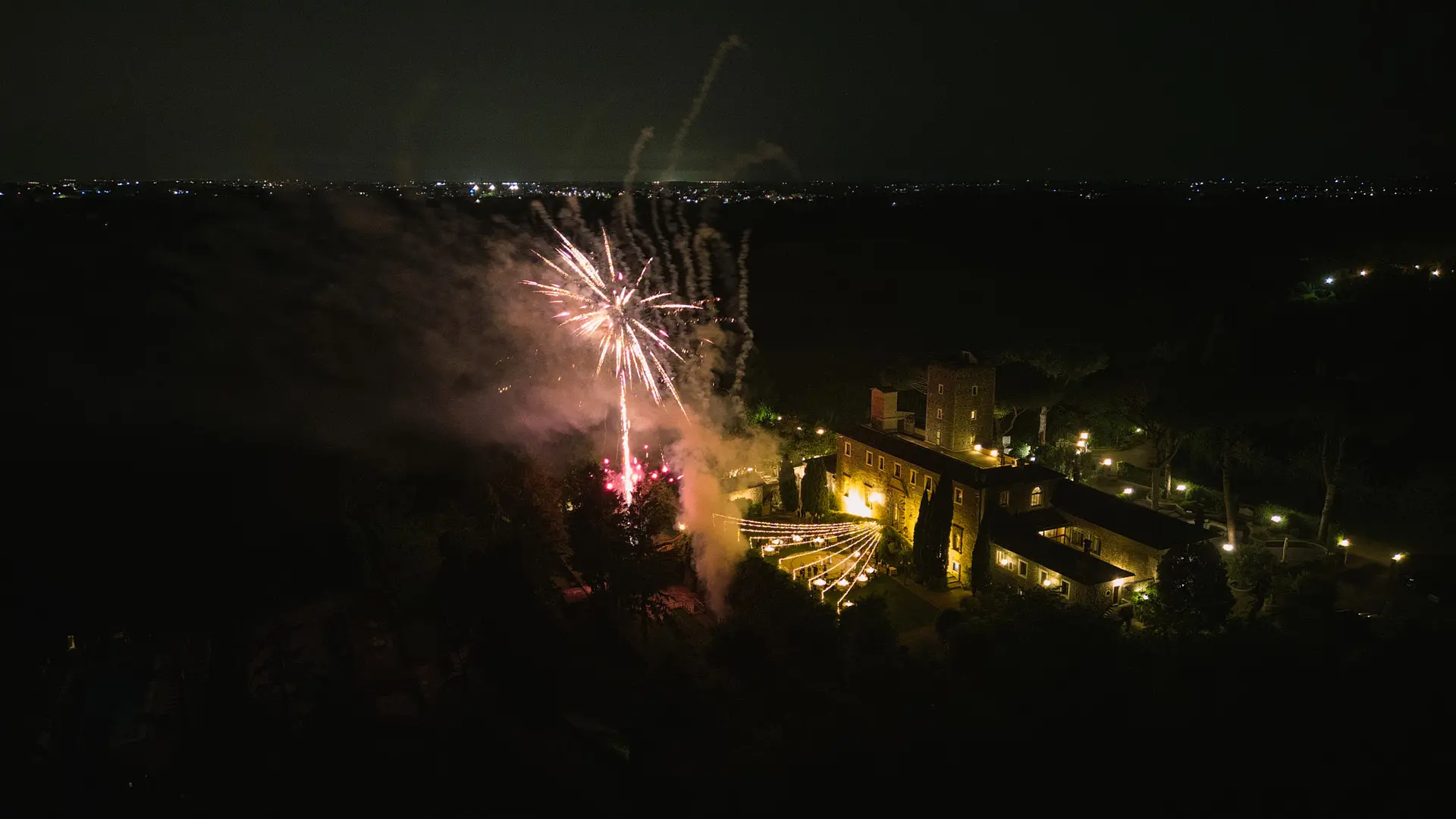 Fireworks over a castle at night, a stunning example of drone wedding photography in Italy.